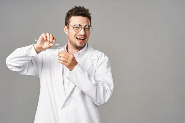 Young Handsome Smiling Doctor Lab Coat Test Tubes Grey Background — Stock Photo, Image