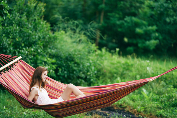 Young beautiful woman relaxing in hammock 