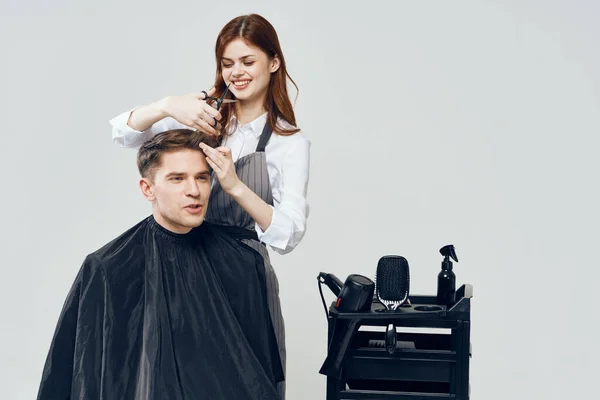 woman hairdresser   making haircut in salon