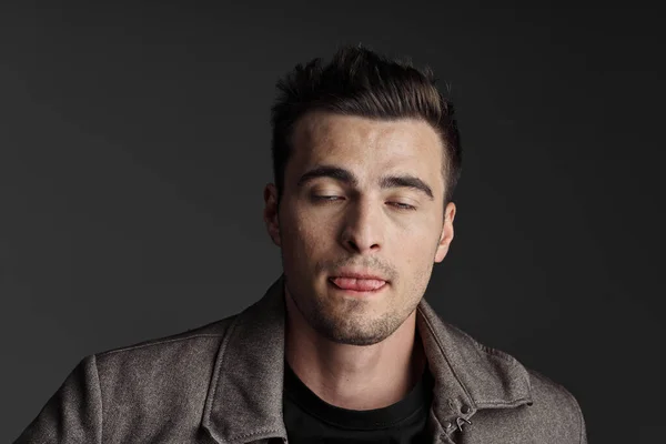 Portrait Young Man Showing Tongue Dark Background Studio Shot — Stock Photo, Image