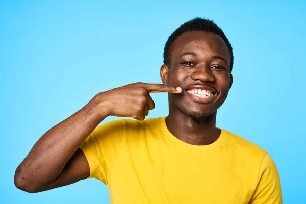 青い背景に孤立した歯を示す若いアフリカ人男性 — ストック写真