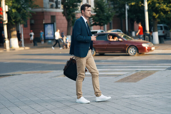 young handsome businessman  walking on the street