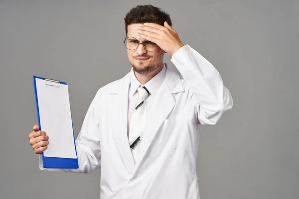 Studio shot. Young sad doctor on  isolated background