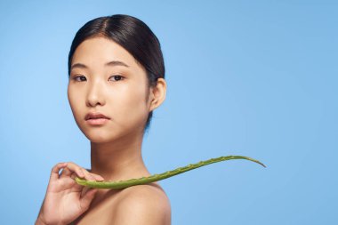 pointing beautiful asian woman with aloe vera leaf 