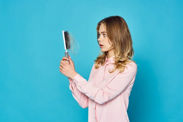 young beautiful woman with hair brush