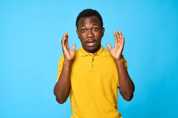 Young african man is  confused    isolated on blue background