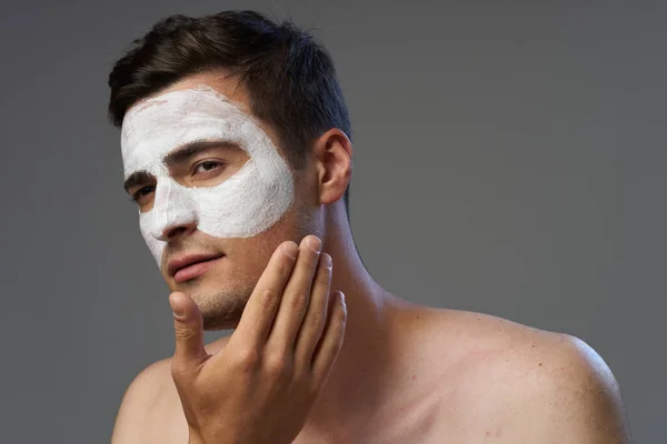 Young Man Applying Facial Mask — Stock Photo, Image