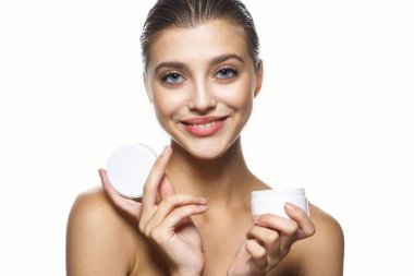 Kremalı güzel bir kadının stüdyo fotoğrafı, izole edilmiş bir arka planda güzellik ürünü.