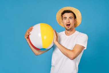Young man playing with ball in studio  clipart