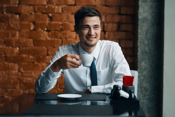 Young  businessman  with coffee  in the office