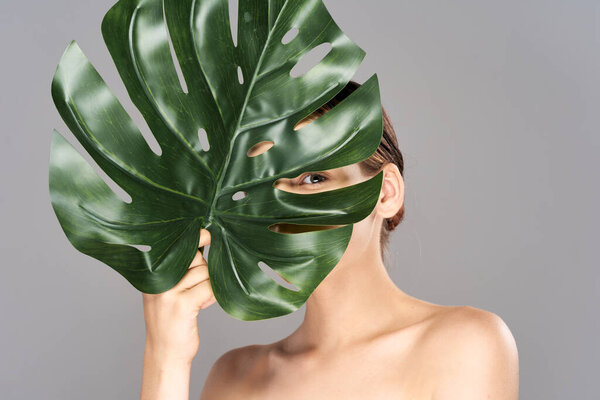 Young beautiful wman  posing with leaf in studio