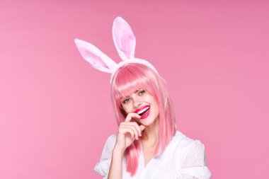 Tavşan kulaklı genç bir kadın stüdyoda poz veriyor. 