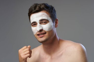 Genç adam yüz maskesi takıyor. 