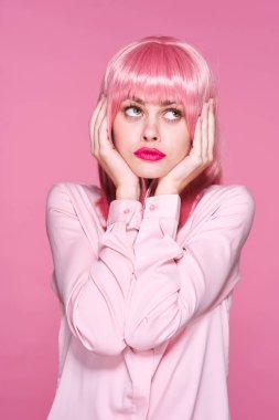 Stüdyoda poz veren pembe peruklu güzel bir kadın. 