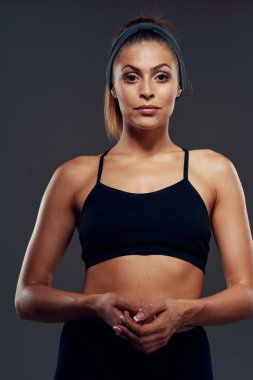 Stüdyo çekimi. Tecrit edilmiş, kaslı, genç bir kadın.   