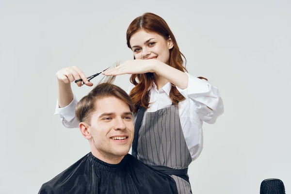 woman hairdresser   making haircut in salon