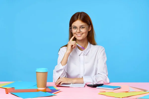 Young  smiling businesswoman isolated on blue background