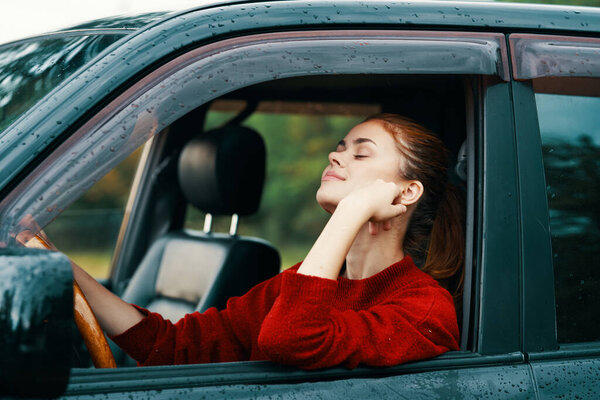 Young beautiful woman driver in the car