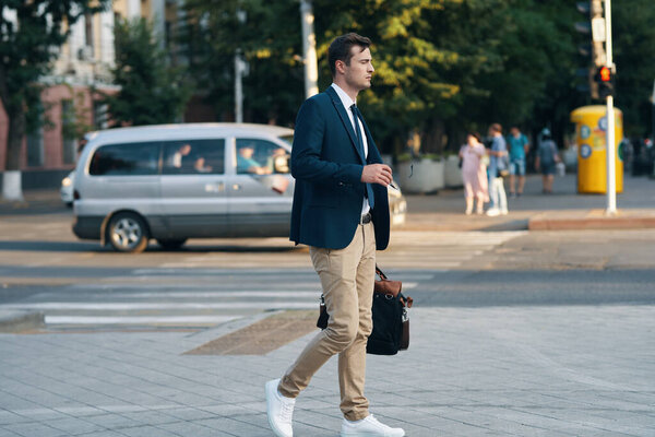 young handsome businessman on the street with bag 