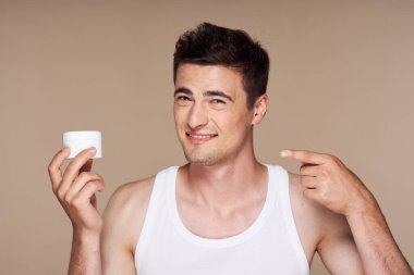 Stüdyo. Güzellik ürünleriyle genç yakışıklı adam.