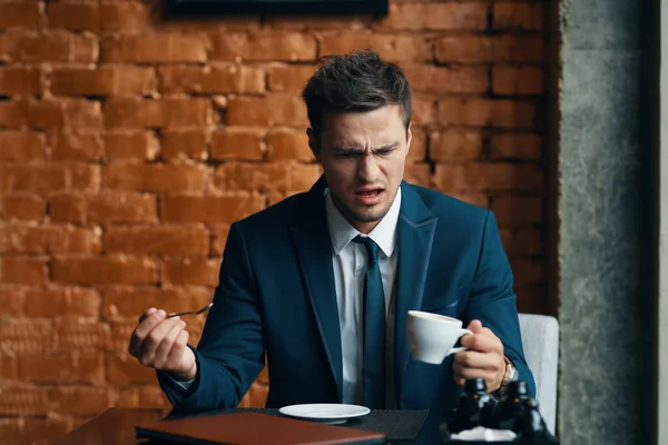 Young angry businessman  having coffee brake