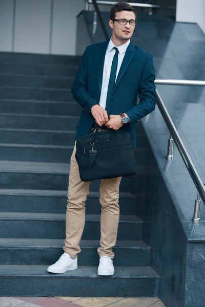 young businessman with bag on the street