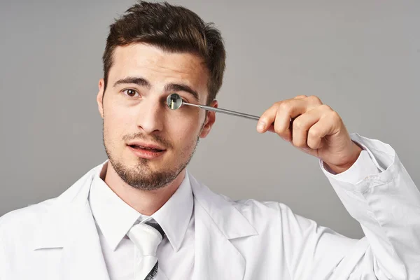 Dentist with medical tool in studio. Medicine, health care