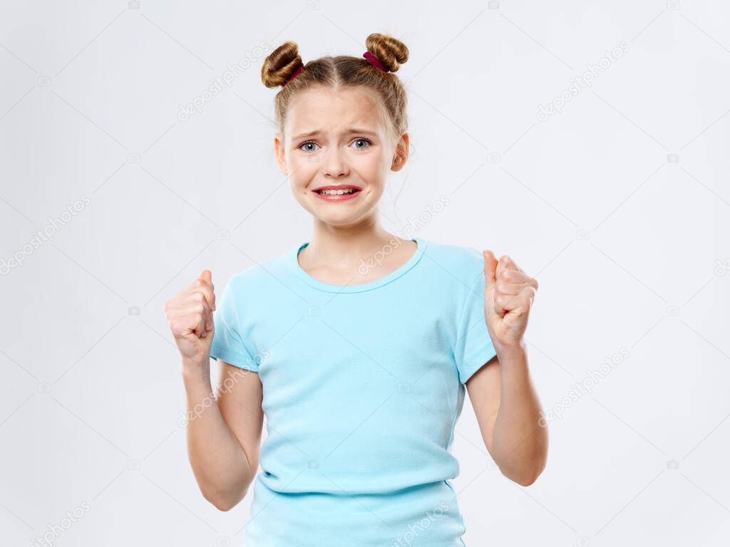 Frightened girl gesticulating with hands hands in fist fear