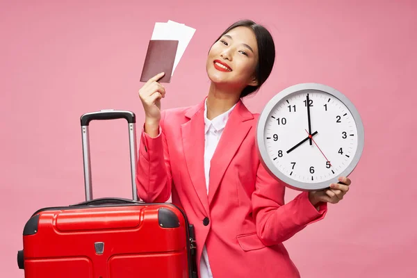 Happy woman goes on a trip with a suitcase passport