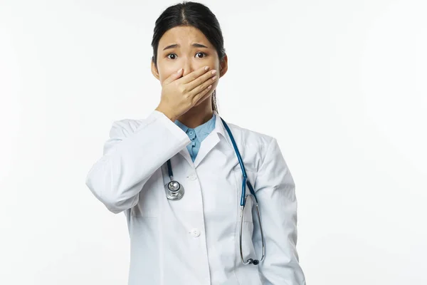 La aterrorizada doctora con un abrigo médico cubrió su cara —  Fotos de Stock