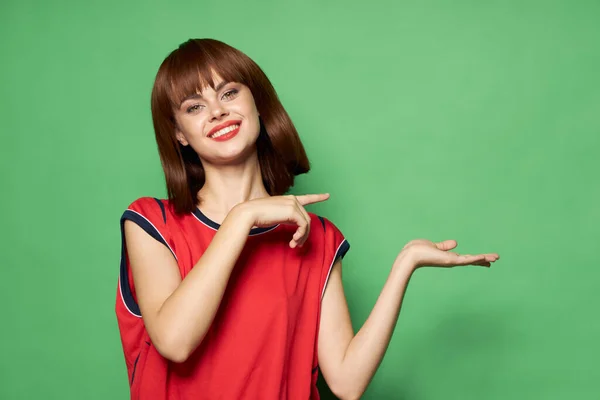 woman gestures with her hands and points the finger to the side