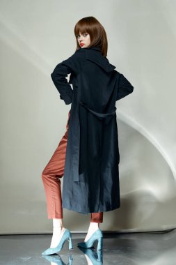 Seksi kadın siyah pelerin modern arka planda izole edilmiş