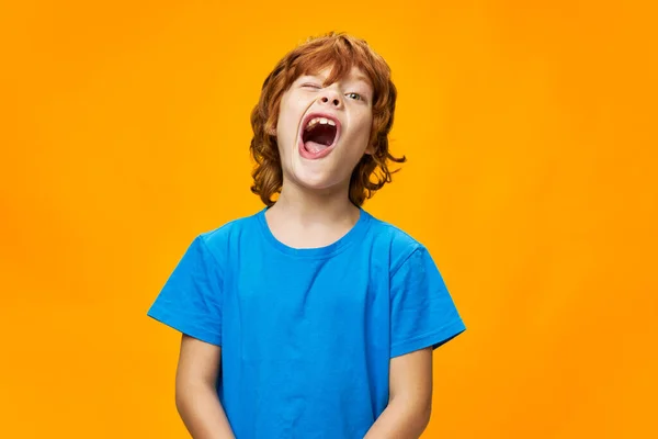 Grimaszoló vörös hajú fiú kék pólóban kivágott kilátással — Stock Fotó