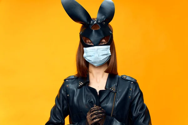 Female rabbit mask posing sexually in a medical mask from coronavirus — Stock Photo, Image