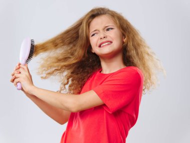 Saçları taranmış, acı içinde bir kız. 