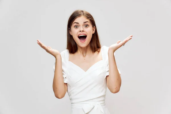 stock image cheerful woman with open mouth throws up her hands white dress cropped view 