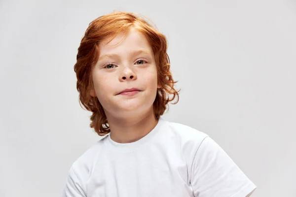 Симпатичний рудий хлопчик у білій футболці спосіб життя крупним планом обрізаний вид — стокове фото