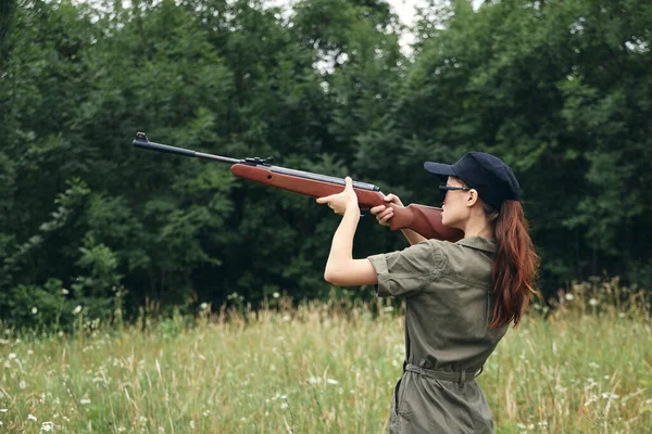 Militar mujer caza vista rifle verde overoles verdes árboles — Foto de Stock