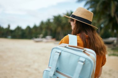 Kadın turist sırt çantası kumsal adasında yürüyor. 