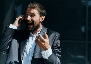 İş adamı telefonda konuşuyor. Duygularını dışa vuruyor. Yönetici yaşam tarzı.