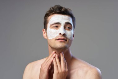 Yüzüne maske takan genç bir adam. Stüdyo çekimi