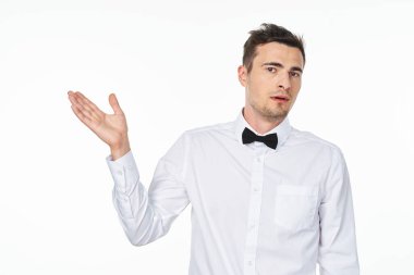 Young   man showing with hand   in studio,  isolated  background