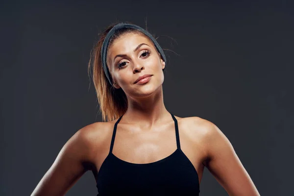 young sporty woman bodybuilder posing in studio