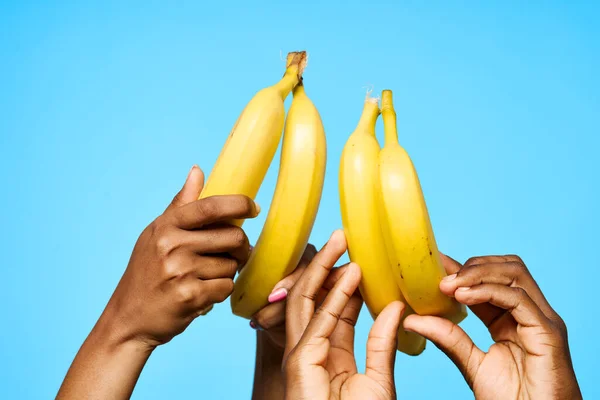 young african coupleholding bananas on isolated background