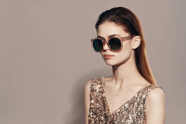  Beautiful young  woman in sunglasses in studio                                                 