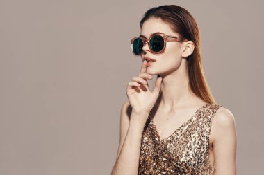  Beautiful young  woman  with sunglasses in studio                                  