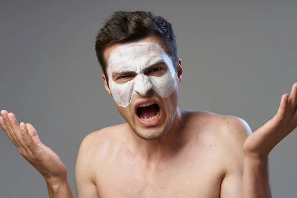 Young handsome man with face mask is angry   in studio