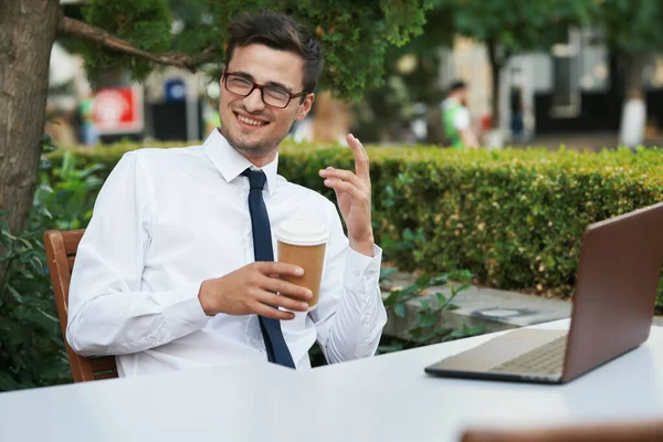 Young handsome businessman with coffee cup