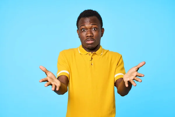 Young african  surprised man   isolated on blue background