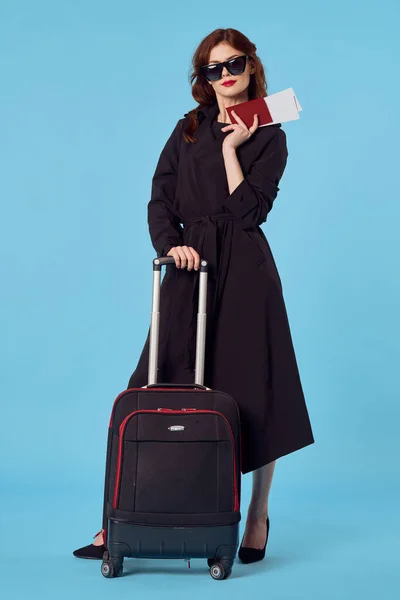 young beautiful woman with suitcase in studio